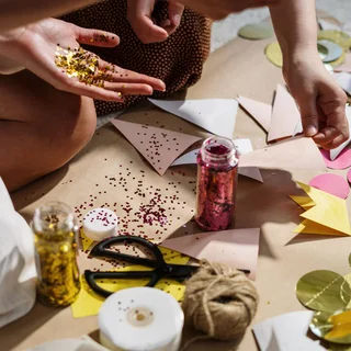 Hands with glitter and paper crafts